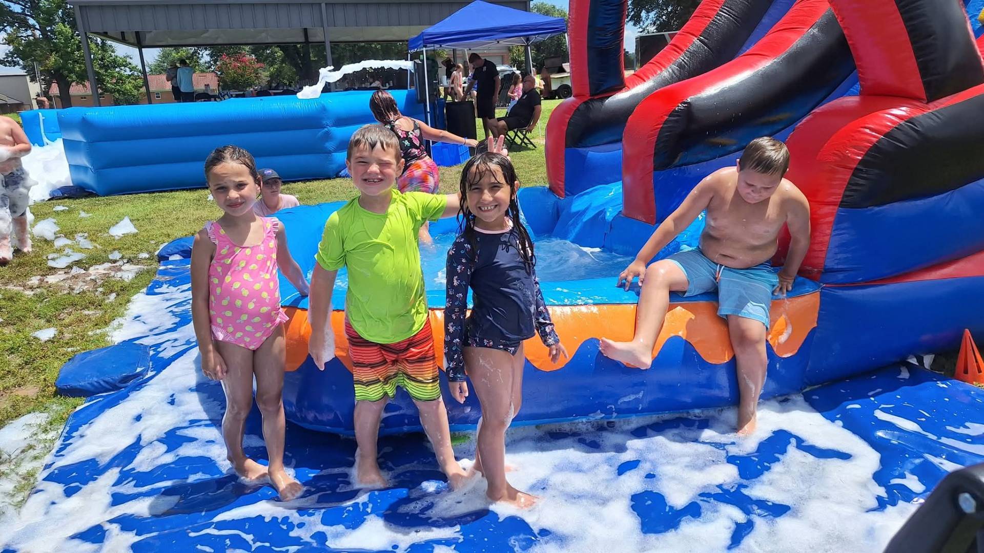 Kids having fun on water slide rental in Fayetteville Arkansas